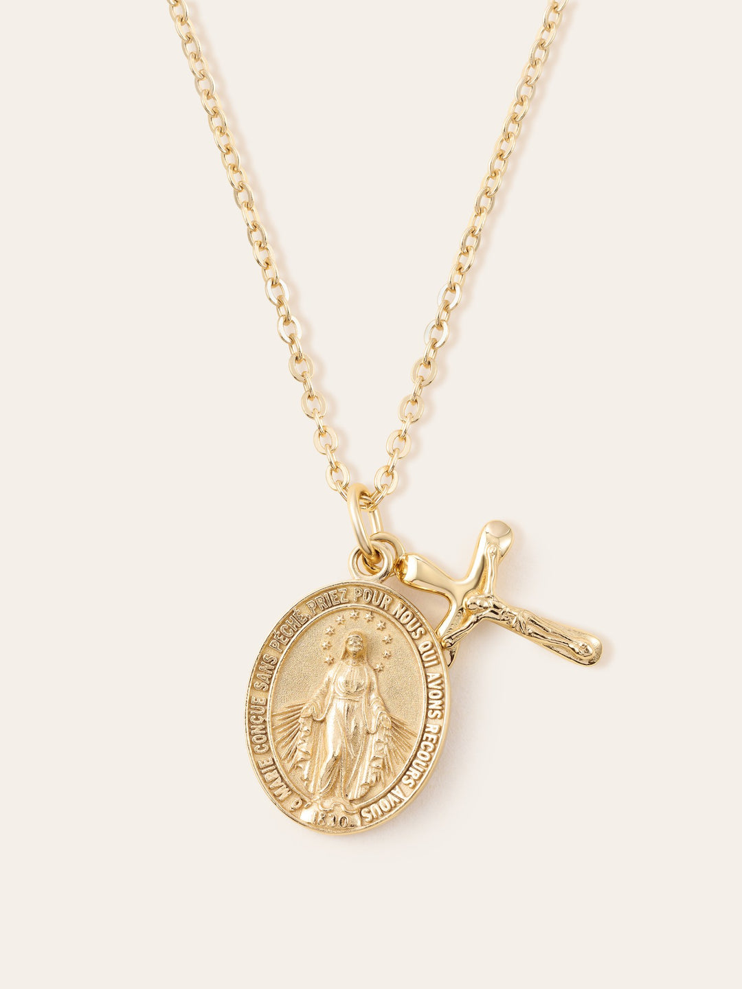 Miraculous Medal &amp; Crucifix Necklace on a cream background